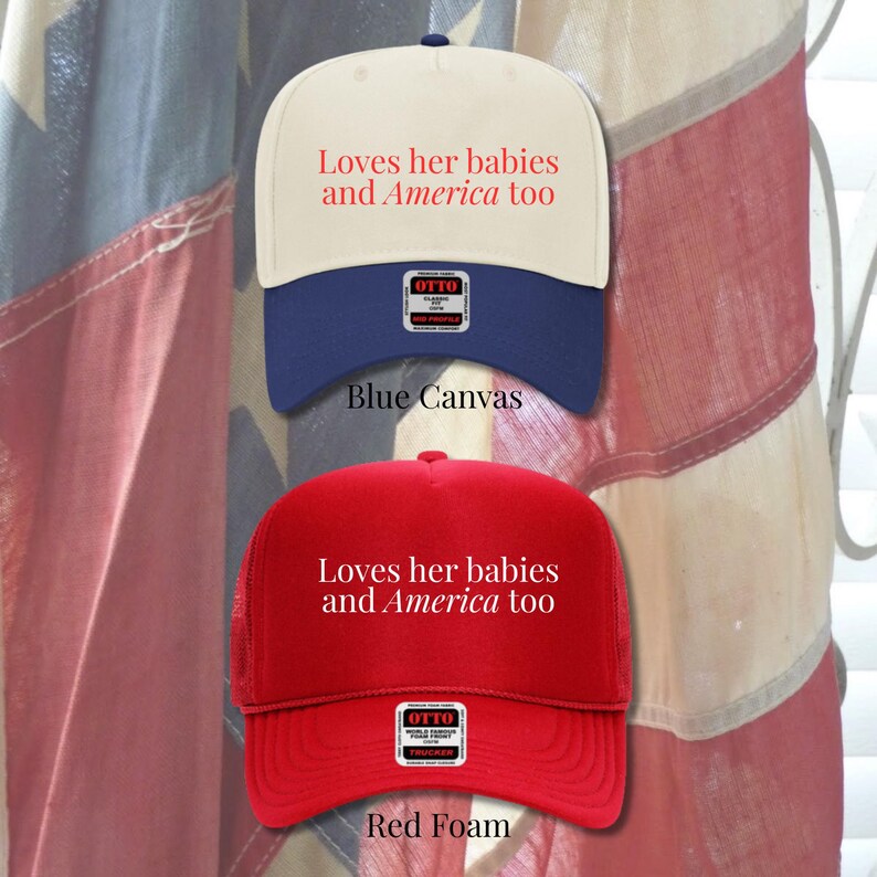 Puede incluir: Dos gorras de b&eacute;isbol, una azul y crema, la otra roja. Ambas gorras tienen el texto "Loves her babies and America too" en rojo. La gorra azul est&aacute; etiquetada como "Blue Canvas" y la roja como "Red Foam".
