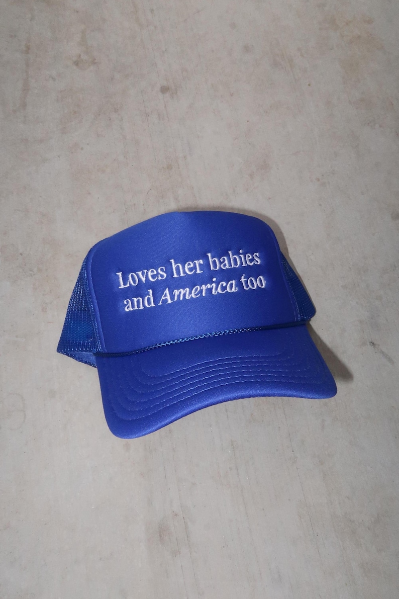 embroidered royal blue foam hat that says Loves her babies and America too