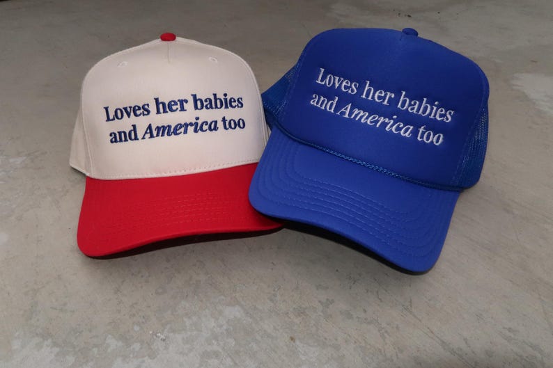 embroidered royal blue foam/ canvas cream and red hat that says Loves her babies and America too