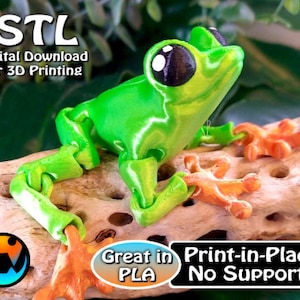 May include: A 3D printed green frog with large black eyes and orange feet. The frog is sitting on a piece of driftwood. The text '.STL Digital Download for 3D Printing' is at the top of the image. The text 'Great in PLA Print-in-Place No Supports' is at the bottom of the image.