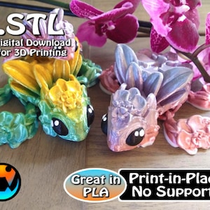 May include: Two 3D printed floral frog figurines, one green and yellow, the other pink and purple. The text "STL Digital Download for 3D Printing" is at the top of the image. The text "Great in PLA Print-in-Place No Supports" is at the bottom of the image.
