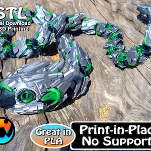 May include: A 3D printed model of a snake with a silver and green color scheme. The snake is posed in a coiled position. The text "STL Digital Download for 3D Printing" is visible in the top left corner of the image. The text "Great in PLA Print-in-Place No Supports" is visible in the bottom right corner of the image.