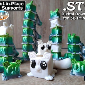 May include: A 3D printed model of a cat, printed in green and white plastic. The cat is designed to be printed in place, without the need for supports. The image includes the text "Print-in-Place No Supports" and "Great in PLA".