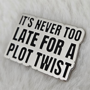 May include: White sticker with black text that reads "It's never too late for a plot twist."