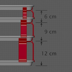 May include: Three gray metal trays with red plastic supports. The trays are stacked on top of each other. The supports are 6 cm, 9 cm, and 12 cm apart.