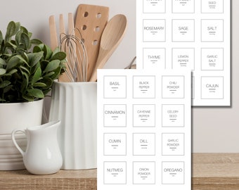 May include: Printable spice jar labels with a minimalist design. The labels feature a black outline and white text with the names of various spices, such as basil, black pepper, chili powder, and cinnamon.