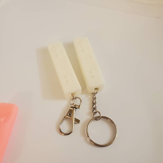 Wii remote keyring pink and white and blue