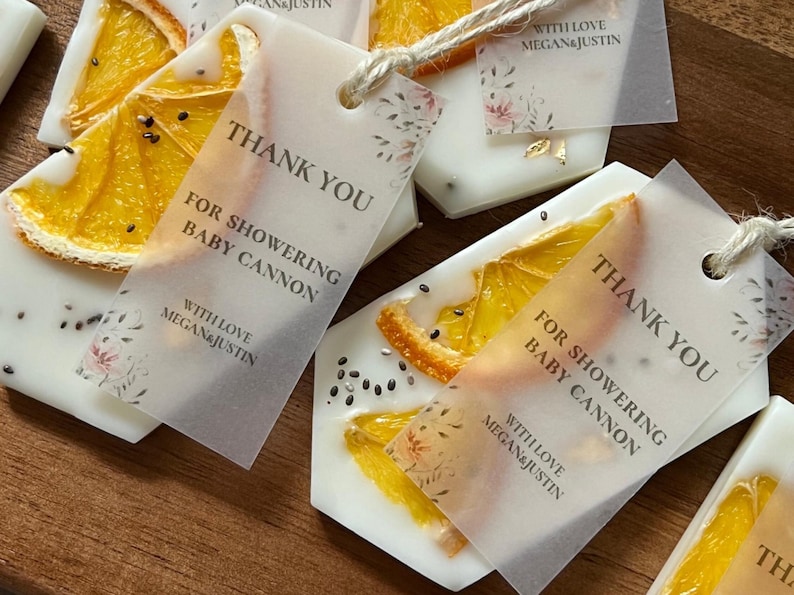 Personalized burnt orange soy wax sachet favors featuring dried orange slices, handmade soy wax air fresheners and custom vellum labels with names and dates. Elegant wedding favors, bridal shower favors, baby shower gifts, engagement party favors and wedding guest favors. Neutral boho decor with natural botanicals and premium fragrance oils. Perfect for wedding welcome bags, bridesmaid gifts, bridal events and special celebrations.