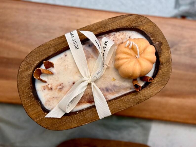 Handmade wooden dough bowl pumpkin candle with soy wax and dried botanicals, perfect as an autumn candle or pumpkin candle gift. Rustic design enhances autumn home decor and autumn decorations, while warm fragrance makes it an ideal Thanksgiving candle. Use as pumpkin decor, cozy centerpiece, or thoughtful Thanksgiving gifts. Unique handmade candles for Thanksgiving decor and seasonal charm, reusable rustic bowl.