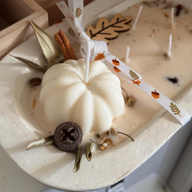 Handmade wooden dough bowl pumpkin candle with soy wax and dried botanicals, perfect as an autumn candle or pumpkin candle gift. Rustic design enhances autumn home decor and autumn decorations, while warm fragrance makes it an ideal Thanksgiving candle. Use as pumpkin decor, cozy centerpiece, or thoughtful Thanksgiving gifts. Unique handmade candles for Thanksgiving decor and seasonal charm, reusable rustic bowl.