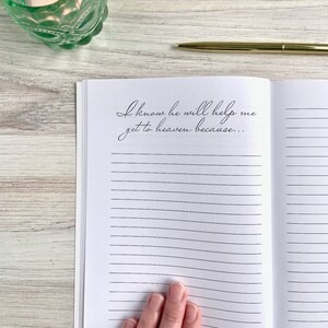 May include: An open journal with lined pages and the text "I know he will help me get to heaven because..." written in black ink.