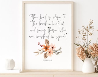 May include: A printable wall art print with a watercolor floral design in shades of orange, pink, and brown. The print features the quote "The Lord is close to the brokenhearted and saves those who are crushed in spirit" and the scripture reference "Psalm 34:18".