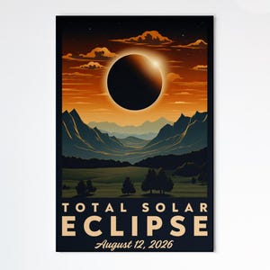 May include: A framed poster showing a total solar eclipse. The image features a dark circle against an orange and yellow sky, with mountains and trees in the foreground. The text "TOTAL SOLAR ECLIPSE August 12, 2026" is at the bottom of the poster.