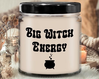 May include: A white candle jar with a black lid and a black graphic that says "Big Witch Energy" with a cauldron and bubbles.