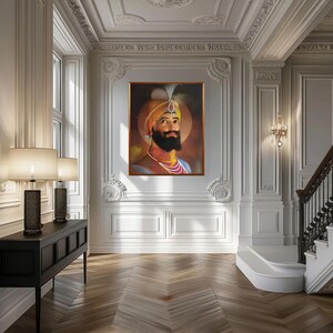 May include: A framed portrait of a man with a beard and turban, wearing a yellow and orange robe. The portrait is set against a dark background with a golden frame.