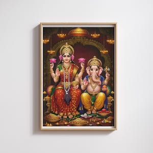 May include: A framed print featuring two figures in traditional Indian attire. One figure is a woman in a red and gold sari, holding a lotus flower. The other is a deity with an elephant head, wearing yellow and blue garments. The background is a dark red with ornate details.
