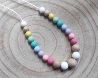 Multicolored rainbow silicone breastfeeding and bottle carrying necklace