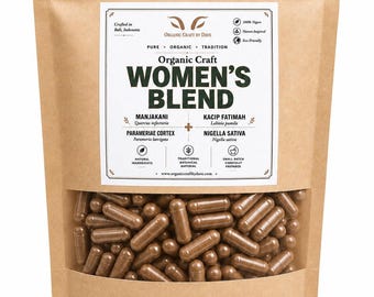 May include: A brown paper bag with a clear window displaying numerous brown capsules. The bag features the text "Organic Craft Women's Blend" and ingredient information. The packaging is labeled as vegan and eco-friendly.
