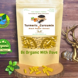 May include: A brown paper package containing Turmeric Curcumin capsules with Black Pepper Extract. The package is displayed on a wooden surface. The text "Be Organic With Dave" is visible. Eco-friendly and organic product labels are also present.
