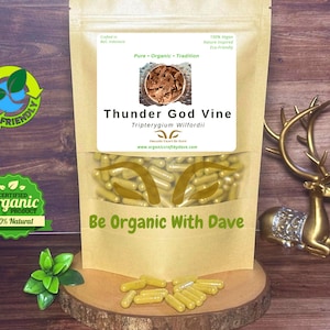 May include: A package of Thunder God Vine capsules, a natural product, displayed on a wooden surface. The package has a clear window showing the capsules. The text "Be Organic With Dave" is visible. An eco-friendly logo and a gold deer statue are also present.