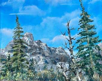 May include: A painting of a mountain lake scene with a blue sky, white clouds, and green trees. The lake is in the foreground, and the mountains are in the background. There are two trees on the left side of the painting, and a single tree on the right side. The trees are all green, and the mountains are gray.