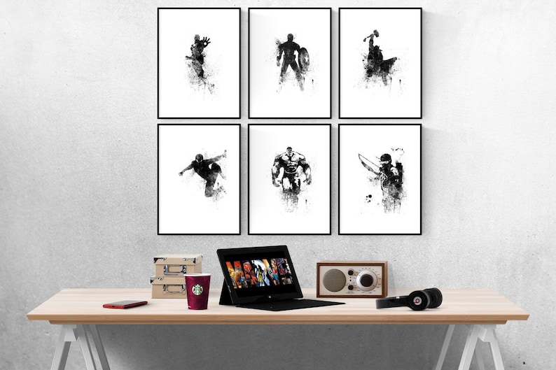 May include: Six black and white framed prints of superhero silhouettes on a white wall. The prints are arranged in two rows of three. The prints are all the same size and have a black frame. The prints are all of different superheroes, including Iron Man, Captain America, Thor, Hulk, Spider-Man, and Hawkeye.