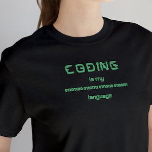 May include: Black t-shirt with a green graphic that says "CODING is my language" with a string of binary code underneath.