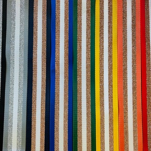 May include: Assortment of 18 striped ribbon trims in various colors, including white, black, gold, silver, blue, green, red, and orange. The stripes are a mix of glitter and solid colors.