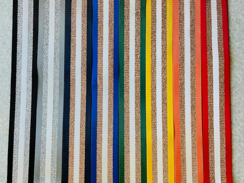 May include: Assortment of 18 striped ribbon trims in various colors, including white, black, gold, silver, blue, green, red, and orange. The stripes are a mix of glitter and solid colors.