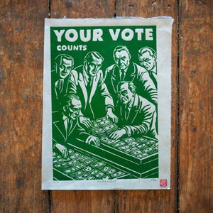 May include: A green and white poster with the text "YOUR VOTE COUNTS" and an illustration of men counting money. The poster is a political statement about the importance of voting.