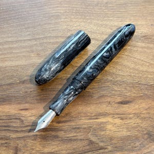 May include: A set of three ceramic mugs with a speckled, matte finish. The mugs are in shades of cream, light brown, and dark brown. Each mug has a simple, minimalist design, perfect for coffee or tea.