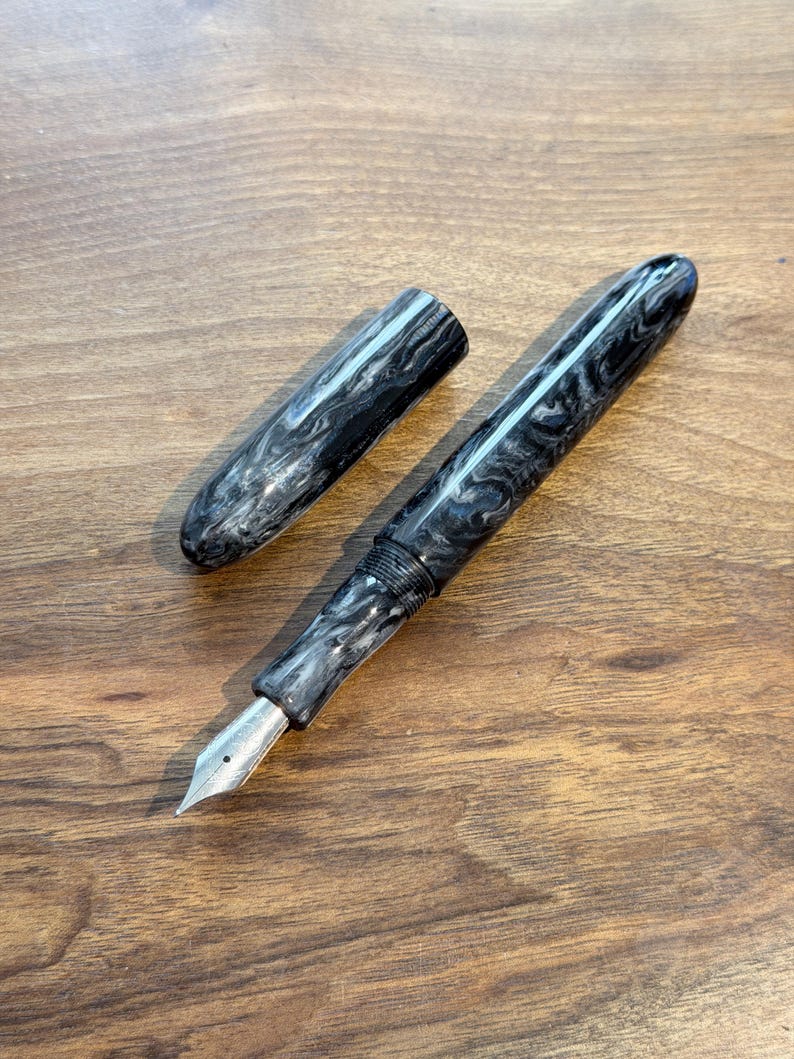 May include: A set of three ceramic mugs with a speckled, matte finish. The mugs are in shades of cream, light brown, and dark brown. Each mug has a simple, minimalist design, perfect for coffee or tea.