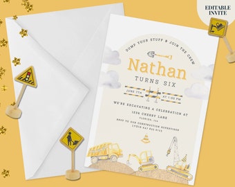 May include: A white invitation card with construction-themed graphics including a dump truck, excavator, crane, and traffic barriers. The text reads Nathan Turns Six, June 7th at 1:00 PM, 1234 Cherry Lane, Florida, 754. Includes a white envelope and three small yellow road signs.