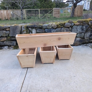 May include: A set of three ceramic mugs with a speckled, matte finish. The mugs are in shades of cream, light gray, and dark gray. Each mug has a simple, minimalist design and a rounded handle.