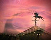 Contemporary photograph of a weathervane againt the sunset, Horse weather vane, Silhouette of weathervane on rooftop, Sunset photo
