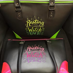 May include: Two black tote bags with the text "Resting Witch Face" embroidered on the front. The top bag has green trim and accents, while the bottom bag features pink trim and accents. Both bags have handles.