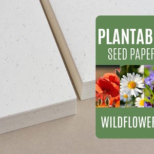 May include: A stack of white plantable seed paper with embedded wildflower seeds. The paper is labeled "Plantable Seed Paper Wildflowers".