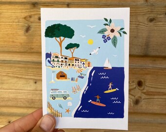 May include: A colorful illustration of a seaside town with a blue van, a beach, and surfers riding waves. The illustration features a blue sky, white clouds, and a yellow sun.
