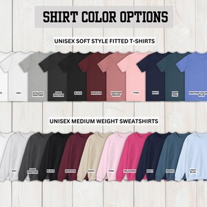 May include: A chart showing different color options for unisex t-shirts and sweatshirts. The t-shirt colors include white, ash, athletic heather, dark heather, black, maroon, heather mauve, pink, navy, deep teal, and heather columbian blue. The sweatshirt colors include white, ash, dark heather, black, maroon, sand, pink, heliconia, navy, indigo, and light blue.