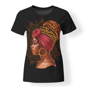 May include: Black t-shirt with a graphic of a woman with a red head wrap and gold jewelry. The graphic is surrounded by a mandala design with the words "Wise, Confident, Prayers, Diva, Flawless, Brave, Girl, Power, Strong, Attitude,  Glamour, Afro" in orange.
