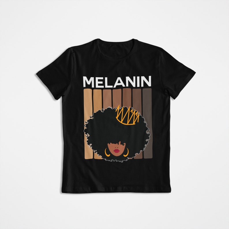 May include: Black t-shirt with the word "MELANIN" in white letters and a graphic of a woman with an afro wearing a crown and earrings. The graphic is surrounded by a series of brown stripes.