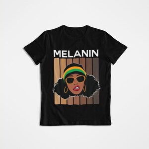 May include: Black t-shirt with a graphic of a woman with brown skin wearing a green and yellow hat and sunglasses. The graphic is surrounded by a vertical stripe pattern of different shades of brown. The text "MELANIN" is printed in white above the graphic.