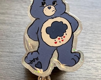 Grumpy blue care bear badge reel/pin
