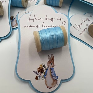 Juegos para baby shower de Flopsy Bunny, juego para medir la barriga, juego para saber qué tan grande es la barriga de mamá, juegos para baby shower, juego para la barriga de Flopsy, adivina la barriga del bebé