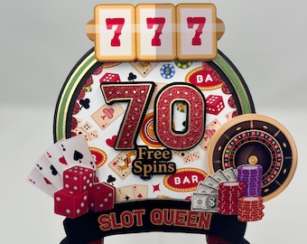 May include: A red and gold casino-themed cake topper with the number 70, the words "Free Spins" and "Slot Queen", and various casino symbols like dice, playing cards, and a roulette wheel.