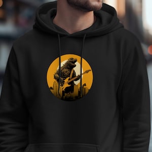 May include: Black hoodie with a graphic of a Godzilla-like creature playing an electric guitar in front of a yellow sun and city skyline.
