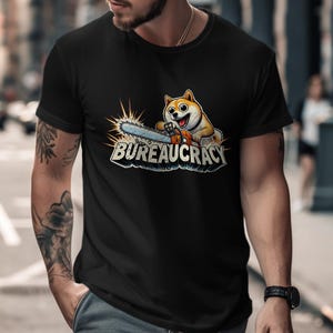 May include: A black t-shirt with a cartoon Shiba Inu dog holding a chainsaw. The text "BUREAUCRACY" is printed below the dog.