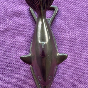 Brass dolphin clip and bottle opener