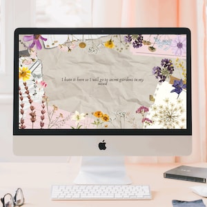 May include: A computer screen displaying a digital desktop background with a collage of dried flowers and the text "I hate it here so I will go to secret gardens in my mind".