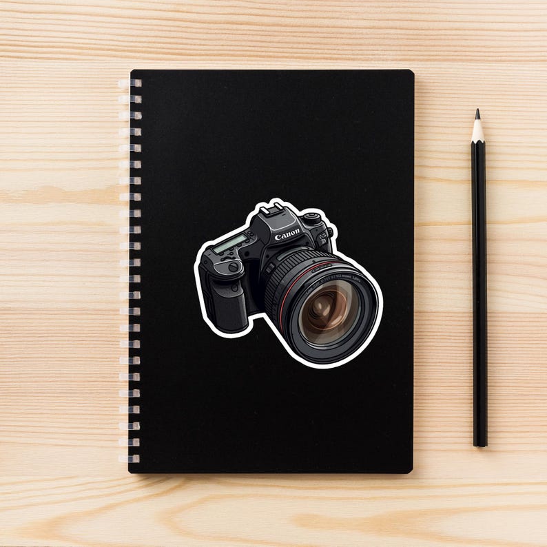 May include: A black Canon DSLR camera with a large lens. The camera has a silver lens ring and a black body with a silver Canon logo.